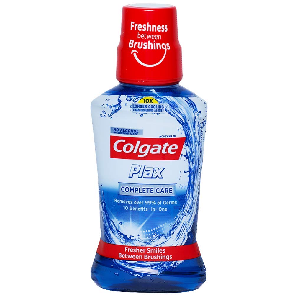 A bottle of Colgate Plax Complete Care mouthwash, 250ml, with a blue and white label featuring a splash of water graphic and the text 'freshness brushes' on the cap.