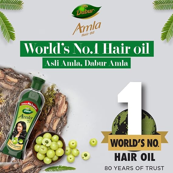 Dabur Amla hair oil advertisement with green amla fruits and leaves on a light background