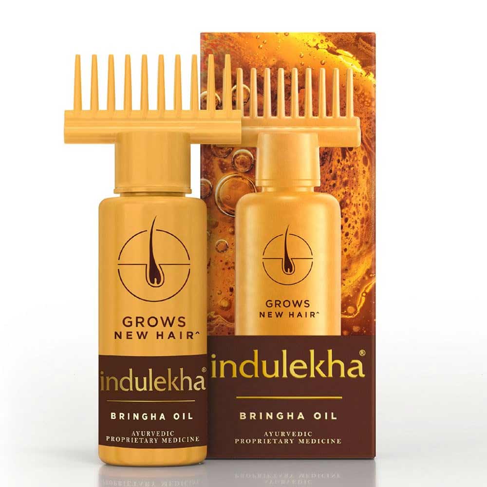 Indulekha Bringha Oil bottles with a comb and packaging on a white background