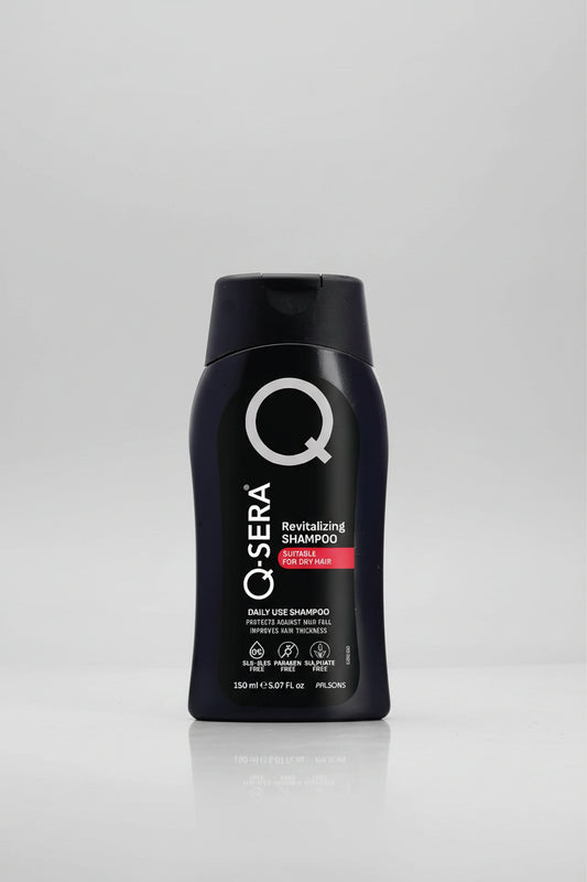 A black plastic bottle of Q-Sera Revitalizing Shampoo with a black cap, featuring white and red text on the front label.